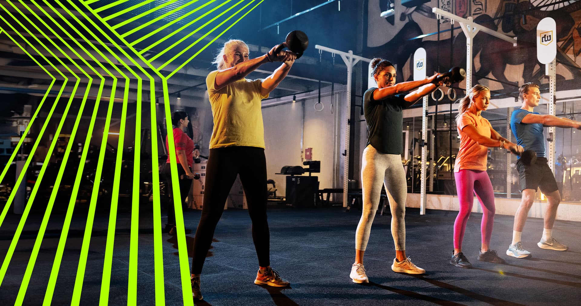 A group of people in the gym using kettlebell weights.