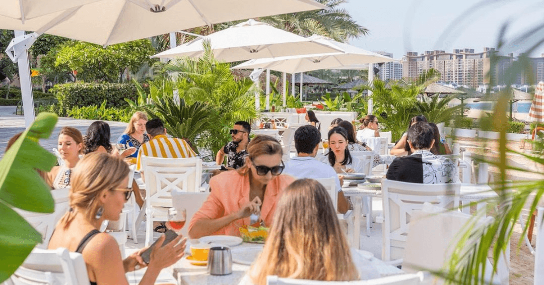 Guests enjoying brunch at Peaches & Cream's beach area.