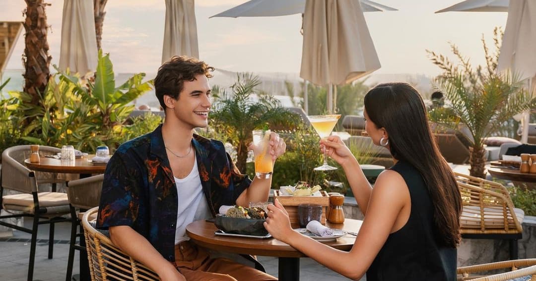 A couple drinking cocktails on the terrace of Ginger Moon