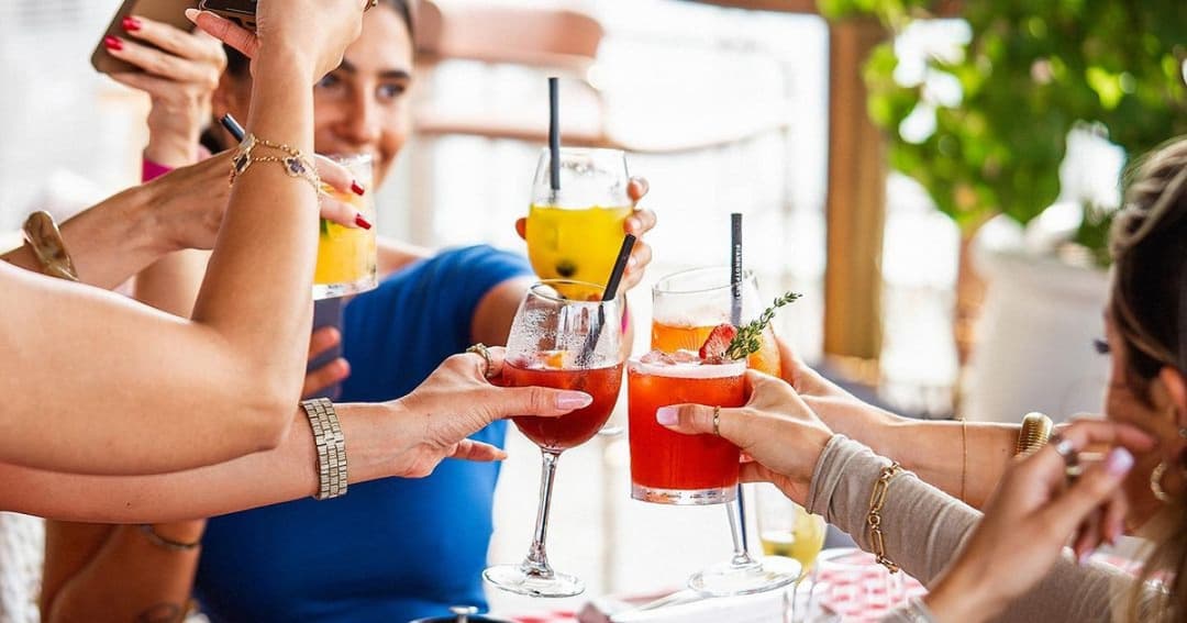 Friends toasting with their cocktails