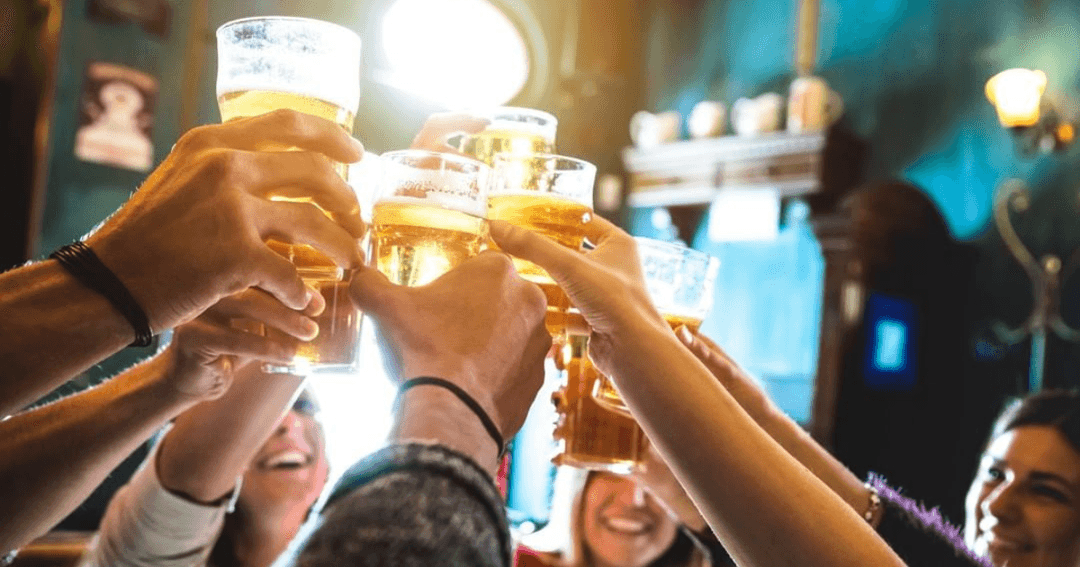 people drinking and cheers-ing at a pub in dubai