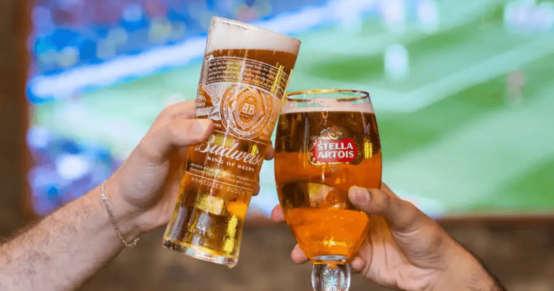 Two pints of beer in front of a TV screen