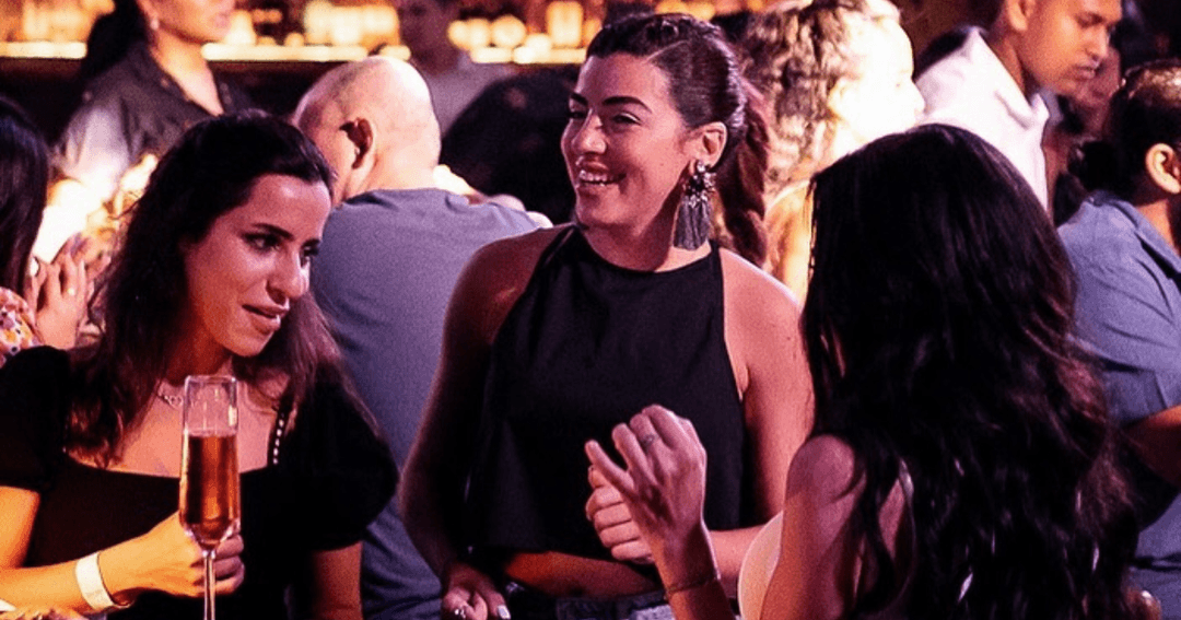 Guests enjoying a vibrant night out at TwentyThree Dubai, showcasing lively conversations and a stylish ambiance.