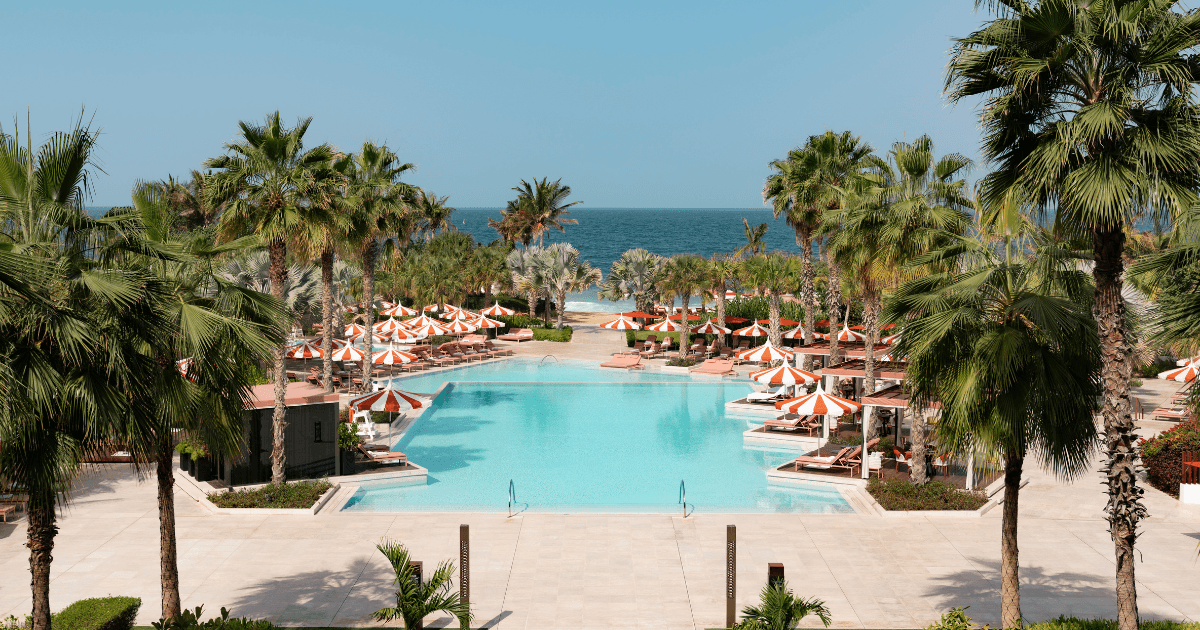Outdoor dining area with pool and ocean view at Alizée, Banyan Tree Hotel, Bluewaters, Dubai