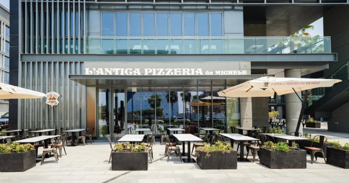 Exterior view of L'Antica Pizzeria da Michele in City Walk, Dubai, featuring outdoor seating and signage.