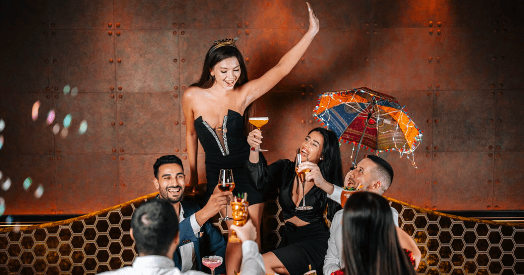 A group of friends celebrating with drinks at Barfly by Buddha Bar