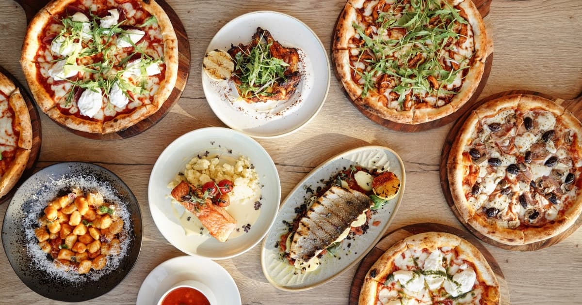 Plates of pizza, pasta and other Italian dishes
